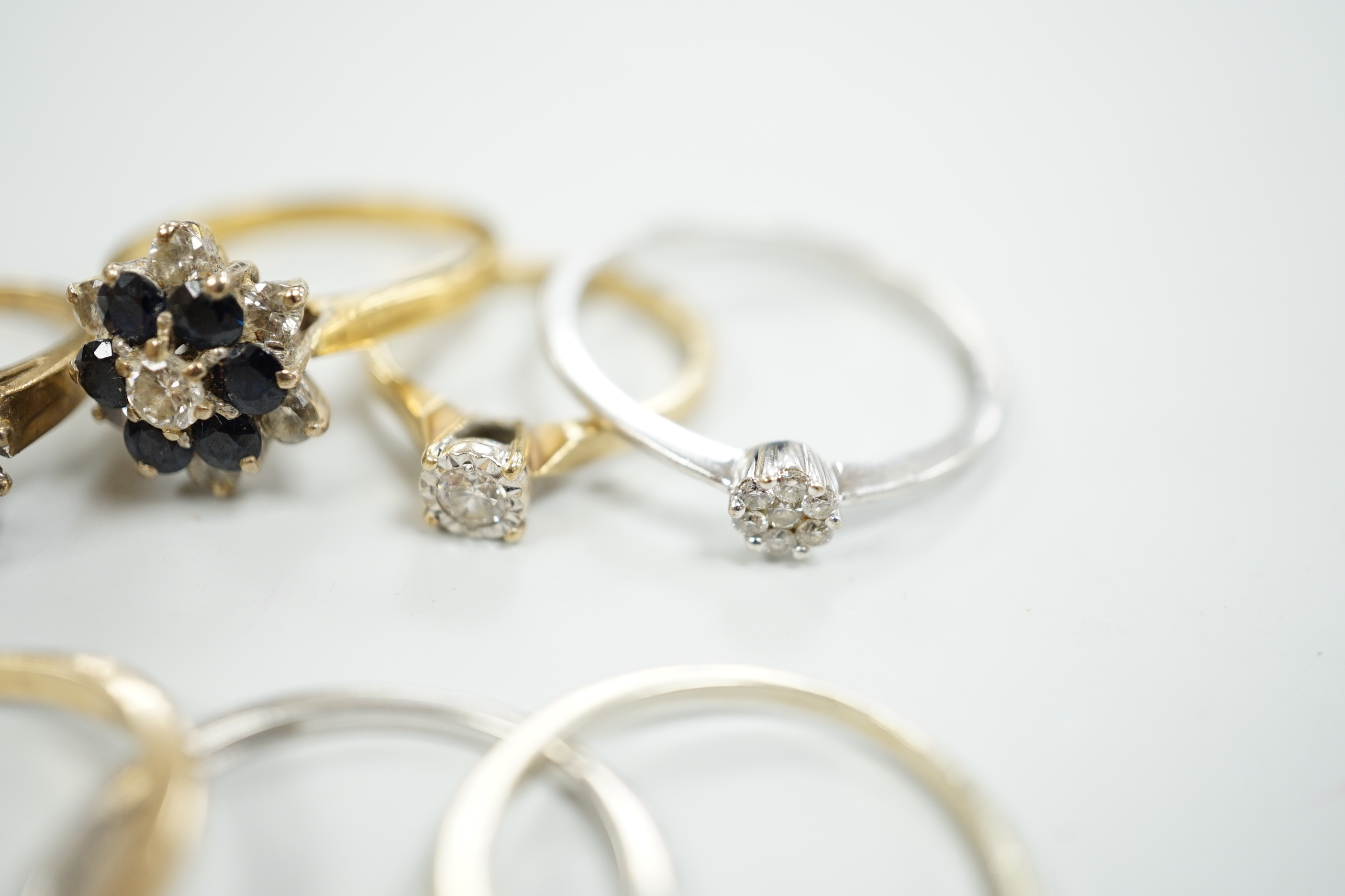 Eight assorted mainly modern 9ct gold and gem set rings, including solitaire diamond and diamond chip half eternity, gross weight 18.8 grams.